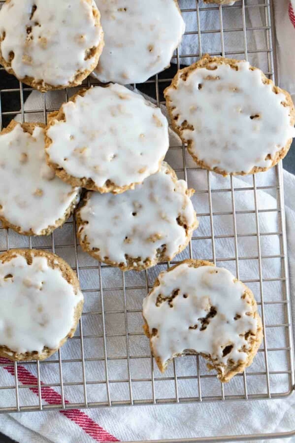 overhead view of iced oatmeal cookies on a baking sheet