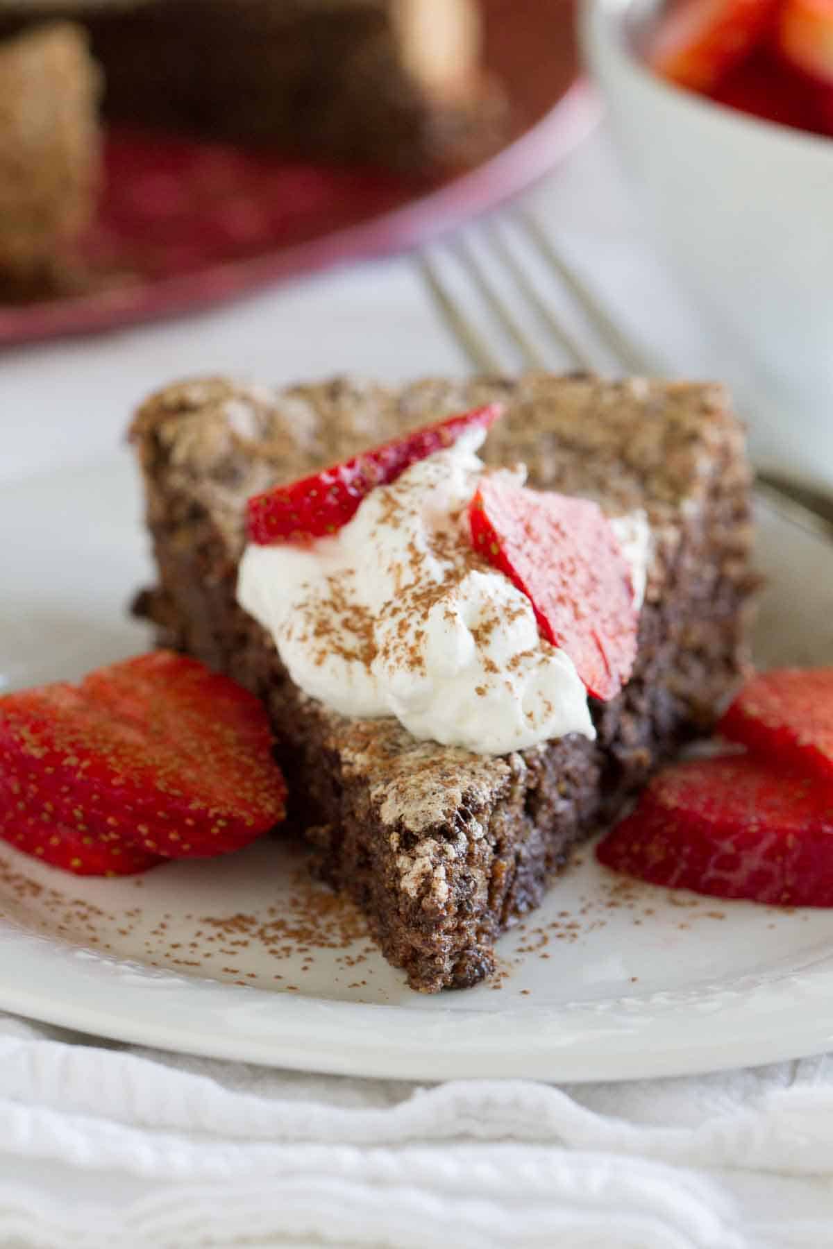 slice of chocolate flourless cake with berries