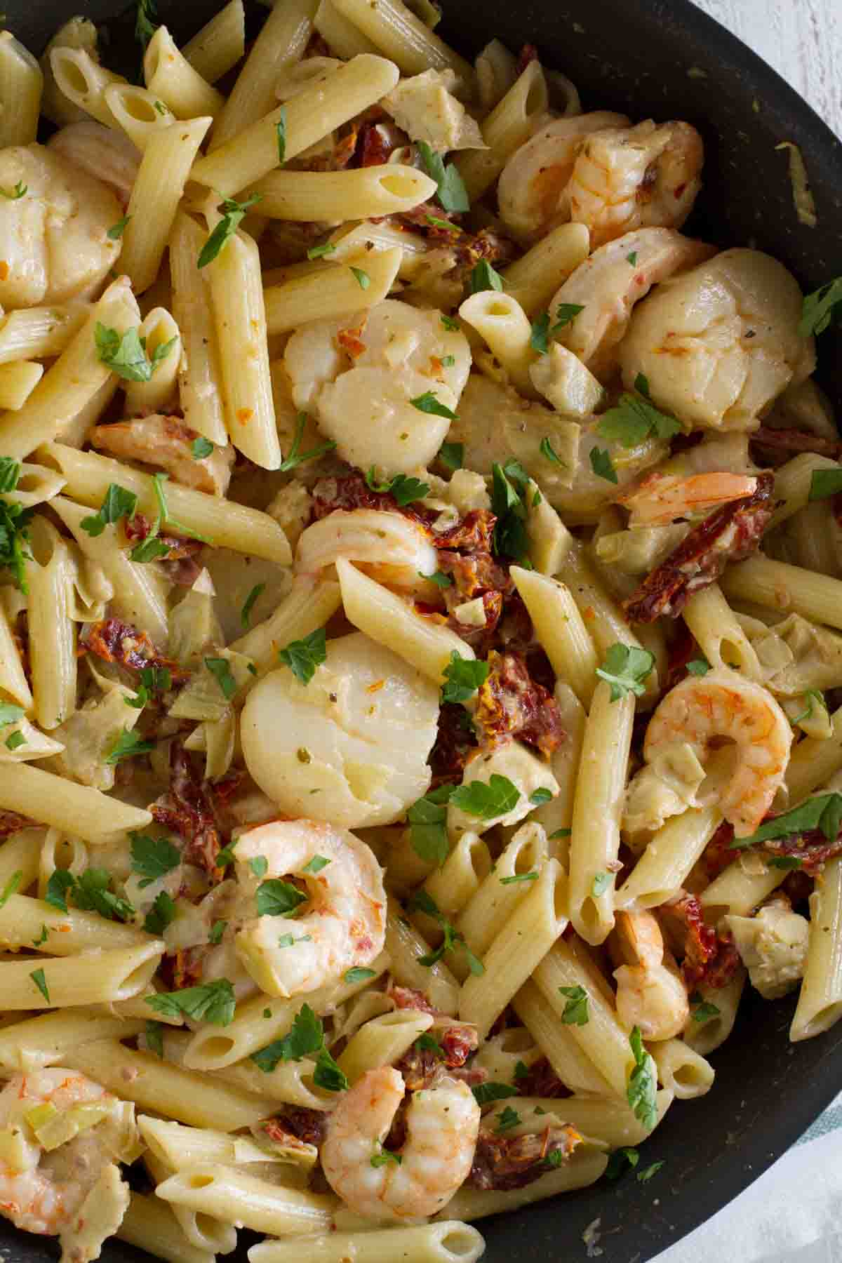 pan full of Key West Penne - pasta with shrimp, scallops, and sun dried tomatoes