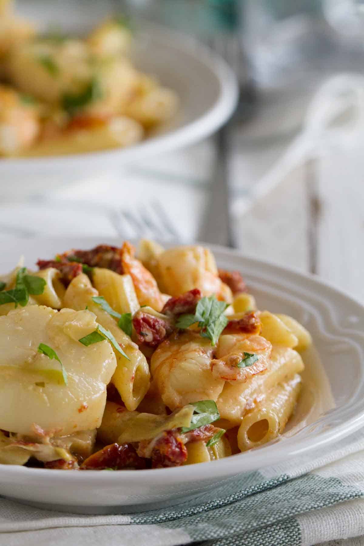 Key West Penne on a plate topped with herbs