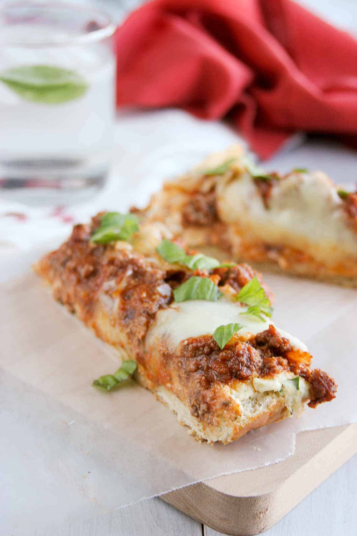 slices of Lasagna Bread Pizza on a cutting board