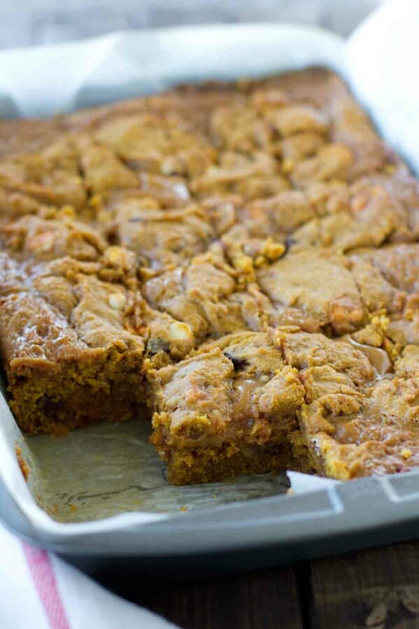 pan of Loaded Caramel Pumpkin Blondies with a few taken out.