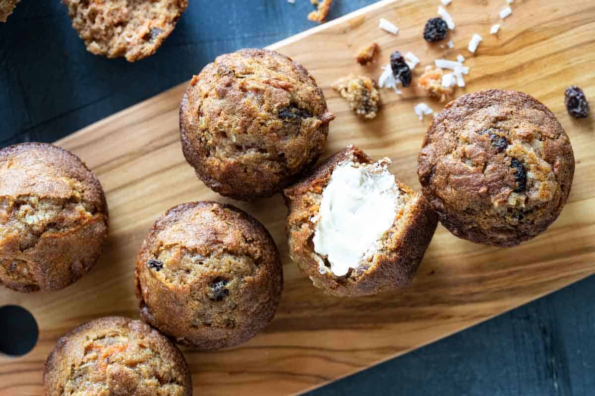 overhead view of morning glory muffins with one spread with butter