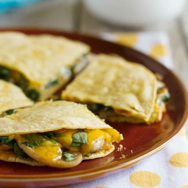 Mushroom Spinach Quesadillas on a plate showing cheese and mushrooms oozing out