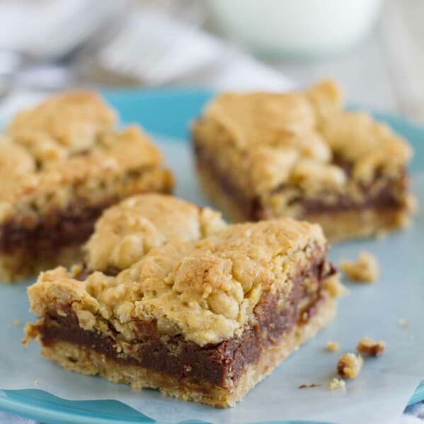 Three Oatmeal Fudge Bars on a plate with parchment under them.