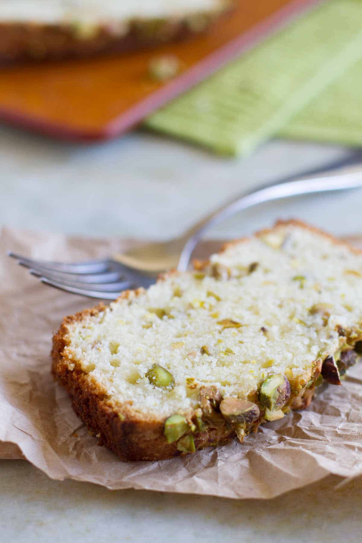 slice of Pistachio Lemon Pound Cake on brown paper