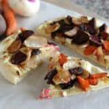 Roasted Root Vegetable Pizza cut into slices