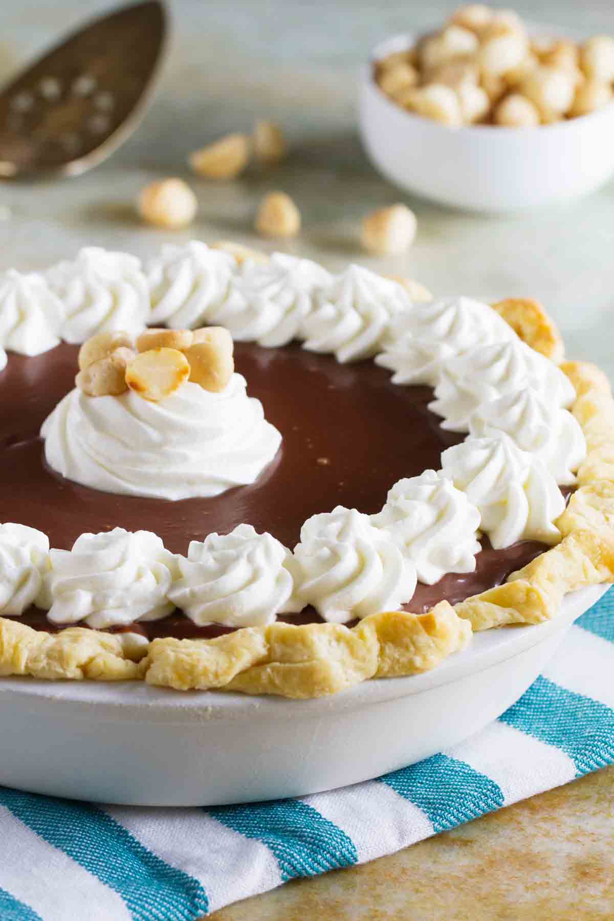 full white chocolate macadamia pie topped with whipped cream