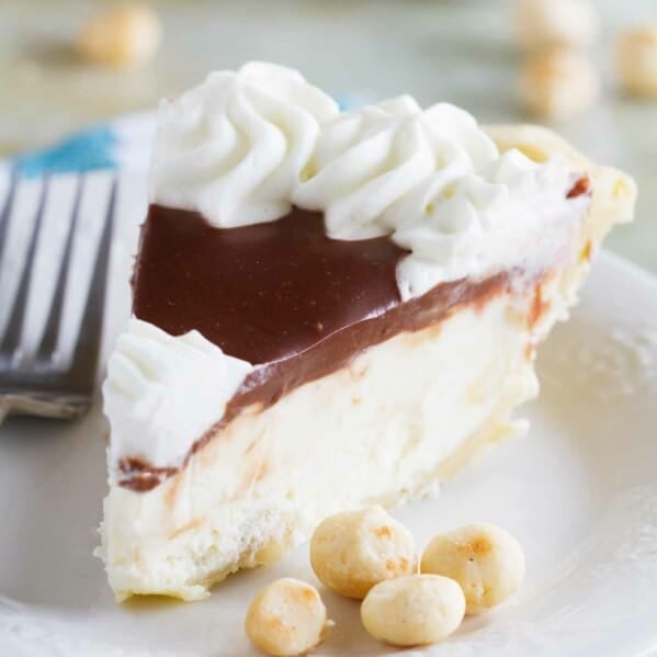 slice of white chocolate macadamia pie on a plate with macadamia nuts