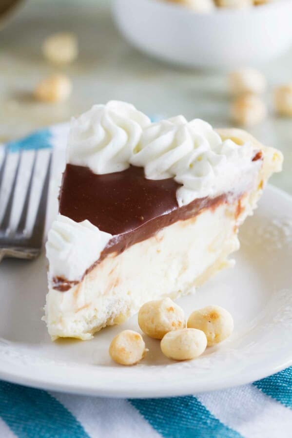 slice of white chocolate macadamia pie on a plate with macadamia nuts