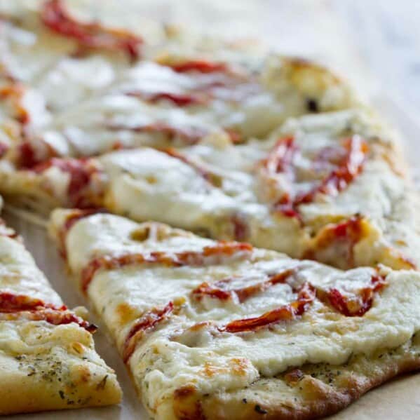 slice of white pizza topped with roasted tomatoes