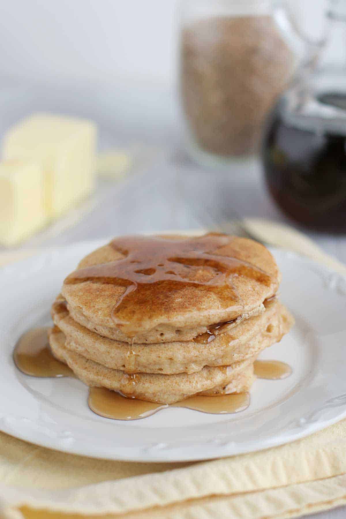 four whole wheat blender pancakes topped with syrup