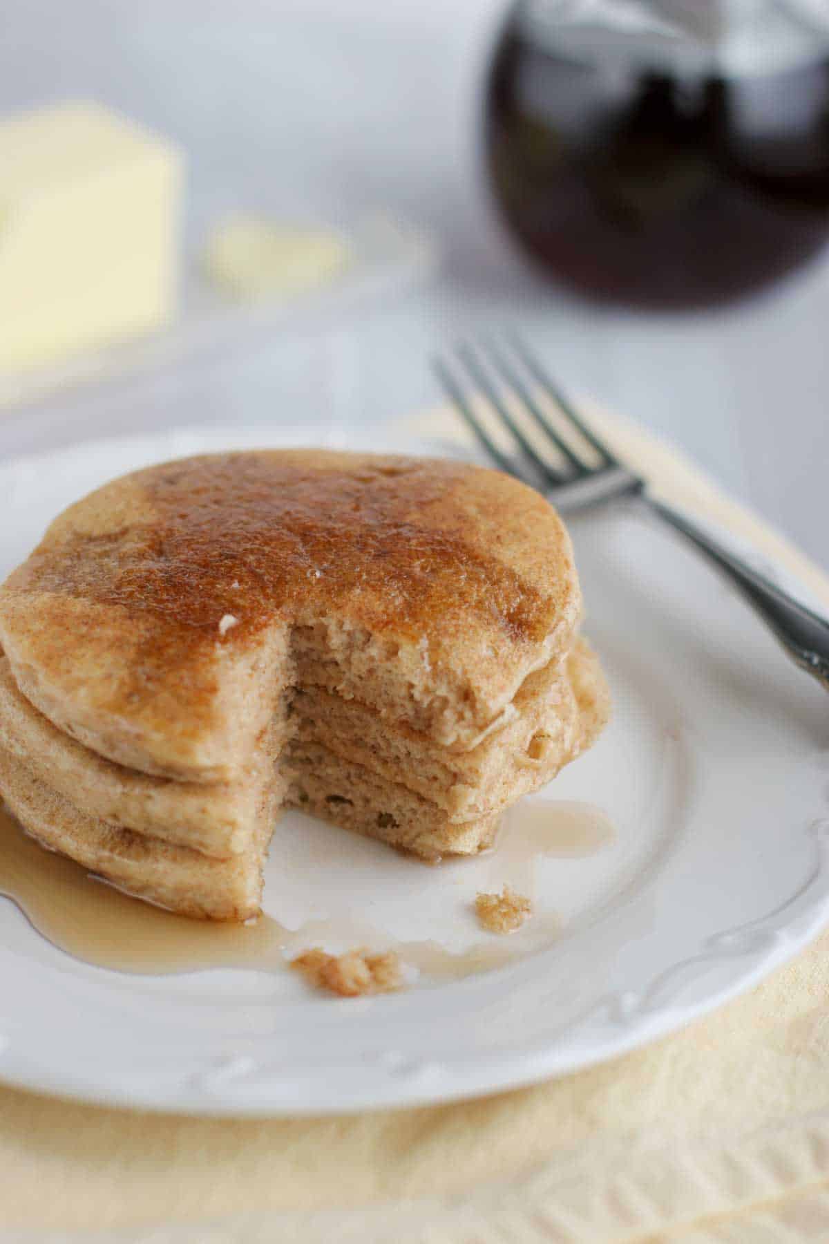 stack of whole wheat blender pancakes with a bite taken from them