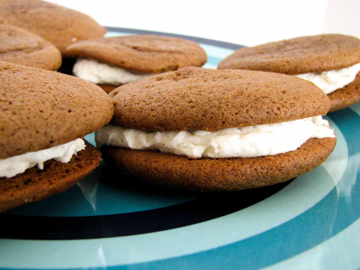 Traditional Whoopie Pies with chocolate cakes and marshmallow filling. chocolate whoopie pies on a blue plate