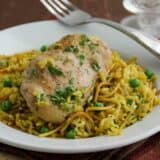 Yellow Chicken and Rice on a plate with a fork