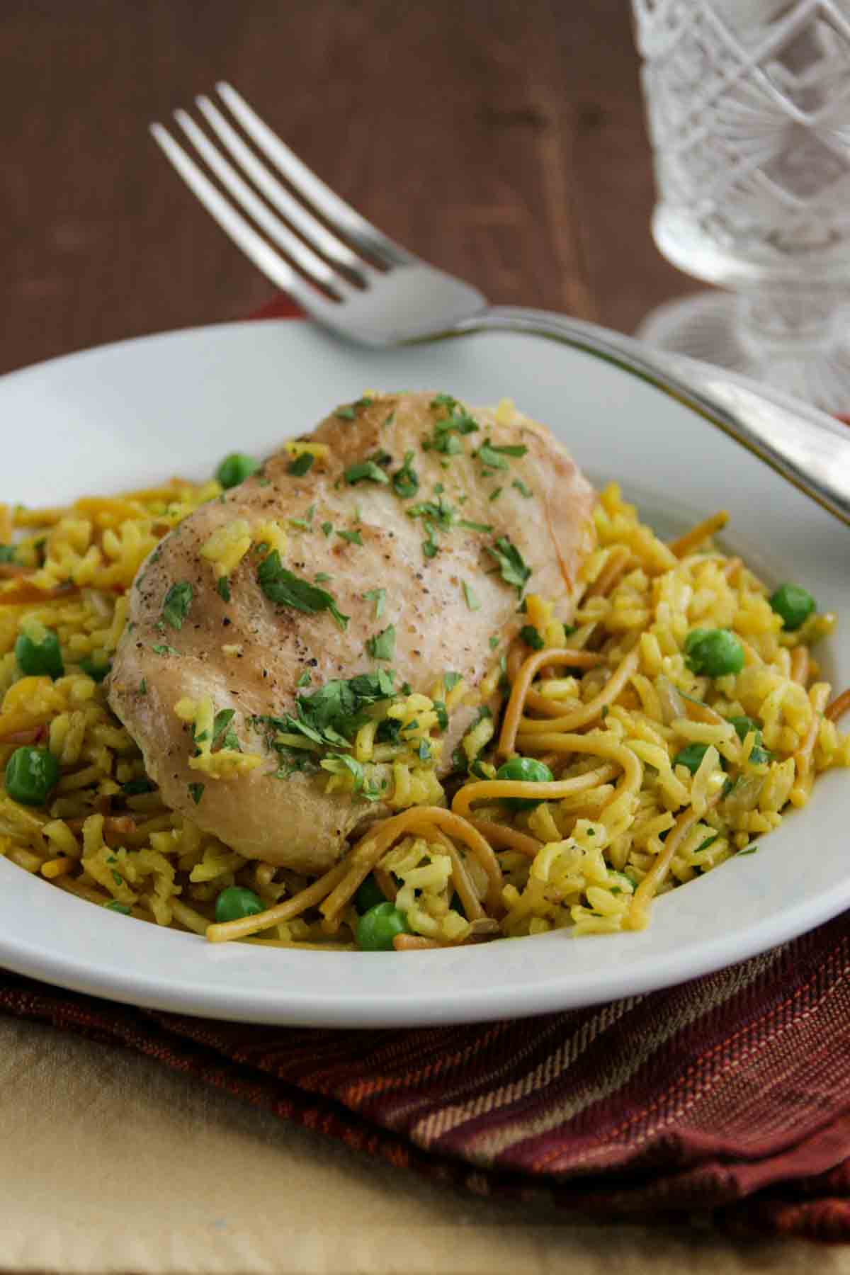 Yellow Chicken and Rice on a plate with a fork