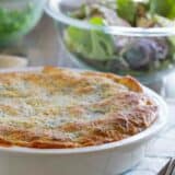 full Zesty Italian Crescent Casserole with a salad behind