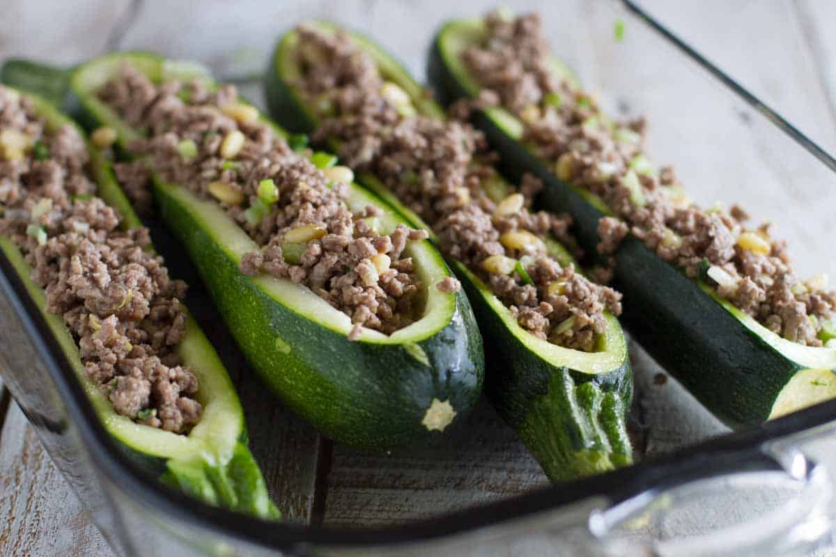 zucchini squash that has been hollowed out and filled with a ground beef mixture