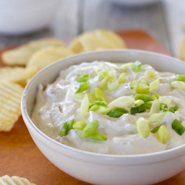 bowl of bacon horseradish dip topped with green onions