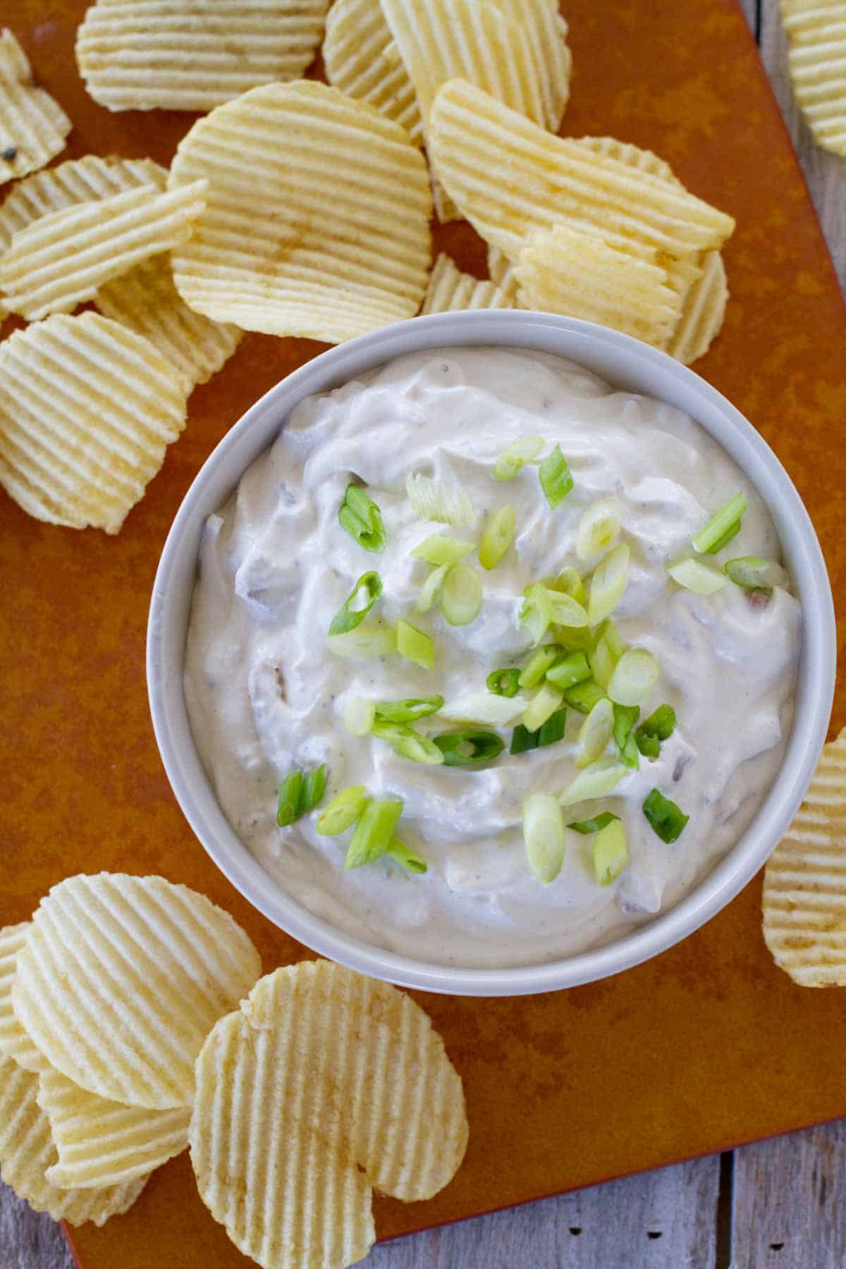 overhead view of bowl of bacon horseradish dip with potato chips