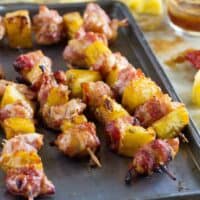 Bacon Wrapped Teriyaki Chicken Skewers on a baking sheet