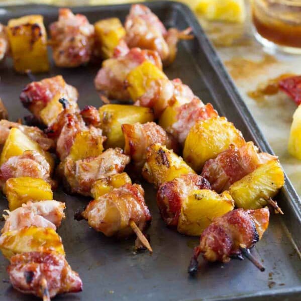 Bacon Wrapped Teriyaki Chicken Skewers on a baking sheet