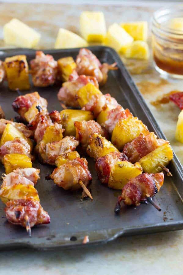 Bacon Wrapped Teriyaki Chicken Skewers on a baking sheet