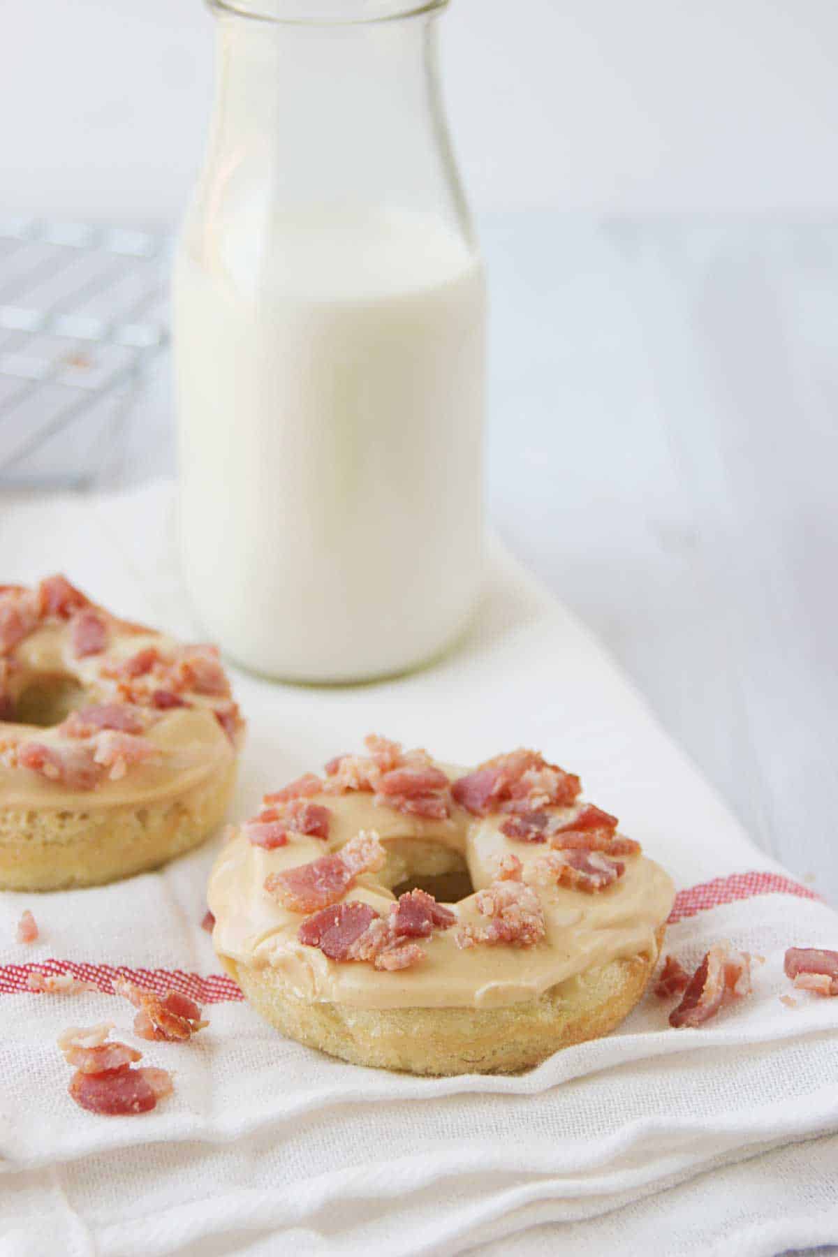 Banana Baked Donuts with Peanut Butter and Bacon with milk behind