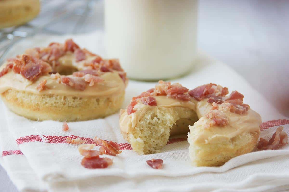 Banana Baked Donuts with a bite taken from one to show texture