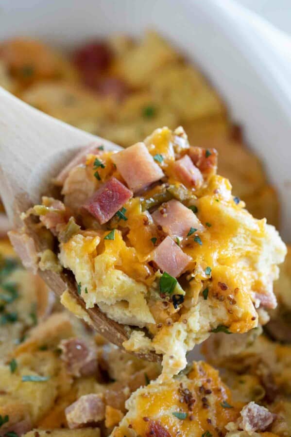 scoop of breakfast casserole with ham and cheese