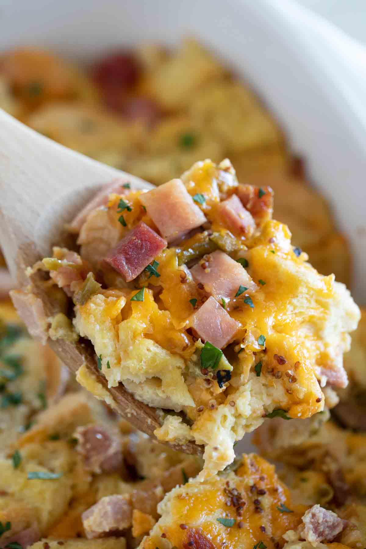 scoop of breakfast casserole with ham and cheese