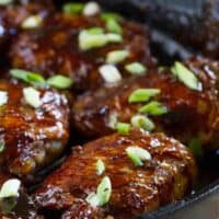 glazed chicken thighs in a cast iron pan