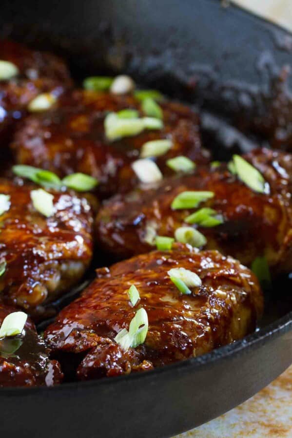 glazed chicken thighs in a cast iron pan