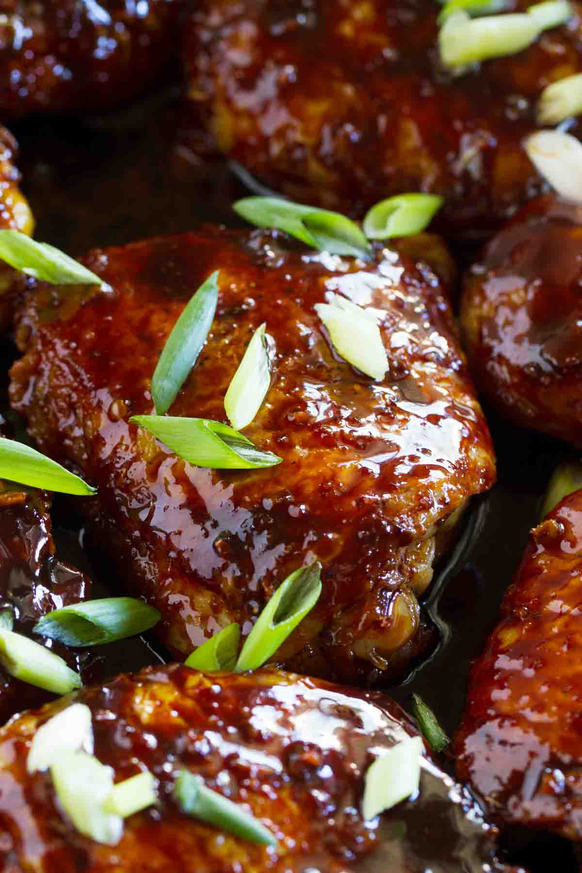 close up of cast iron teriyaki chicken thighs