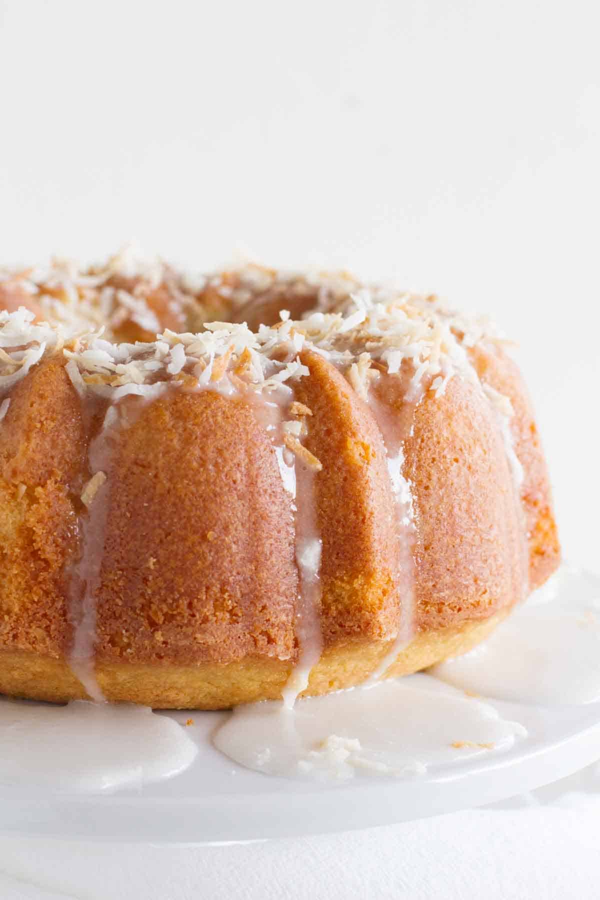coconut bundt cake with icing drizzling down the side