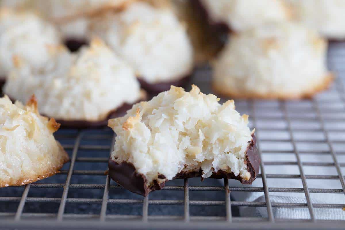 Coconut Macaroon that is dipped in chocolate with a bite taken from it