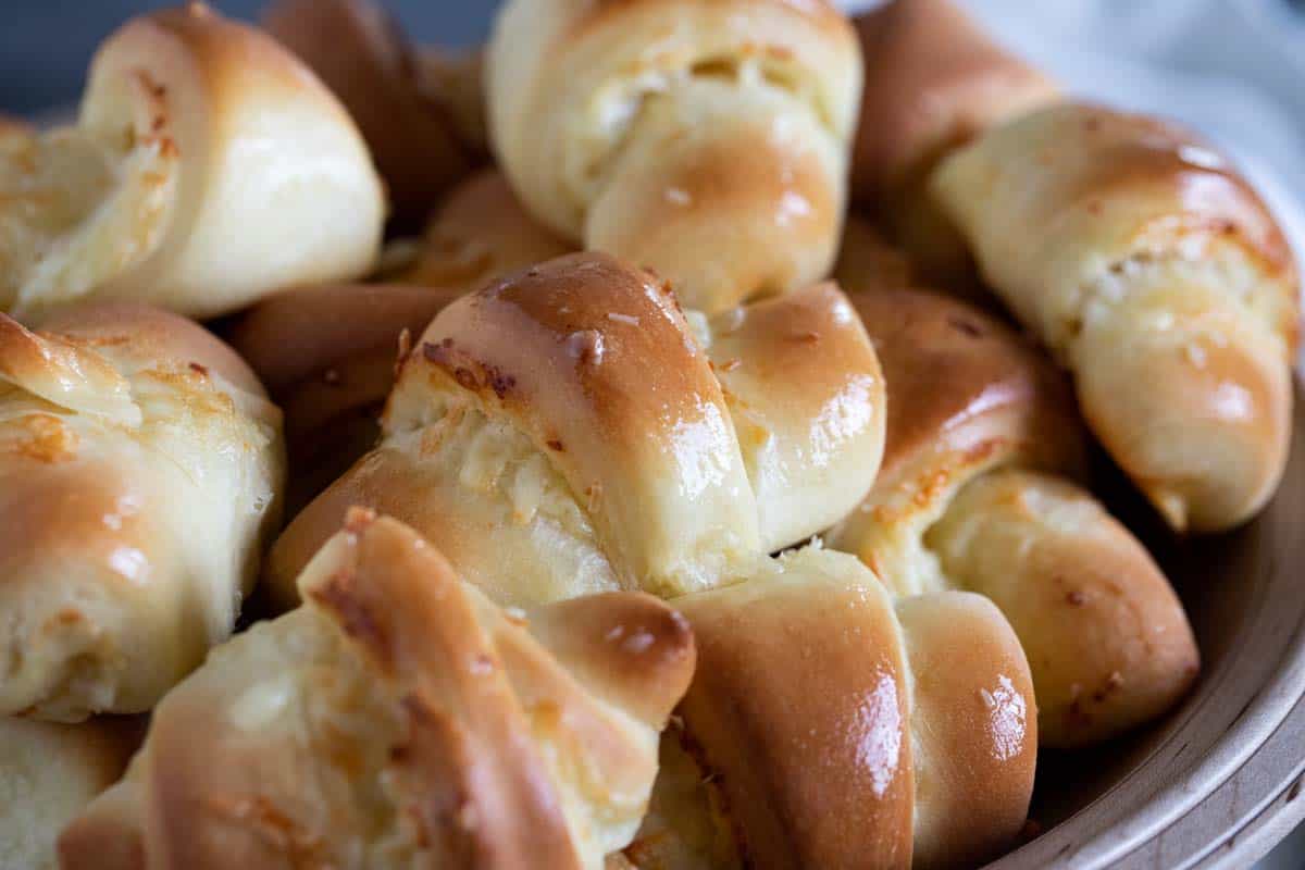 bowl of crescent rolls with cheese stacked on each other.