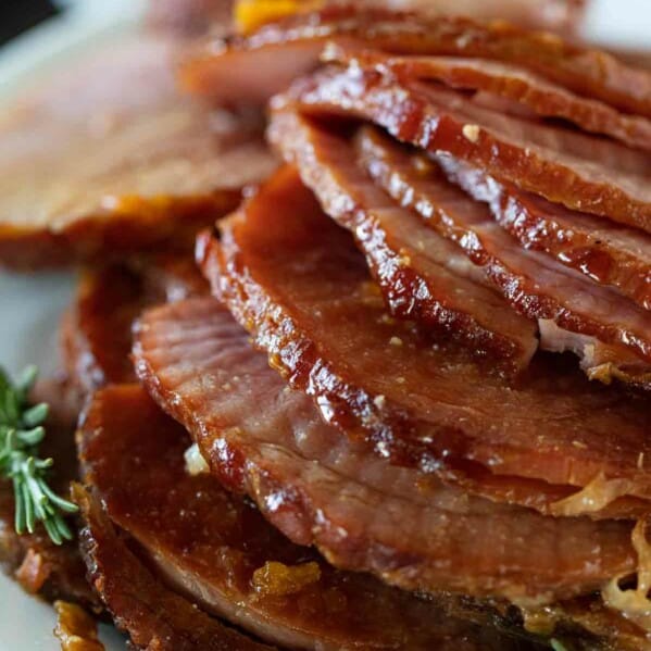 slices of ham stacked on a serving plate