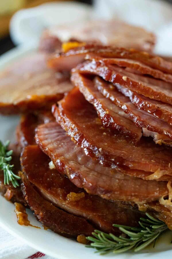 slices of ham stacked on a serving plate