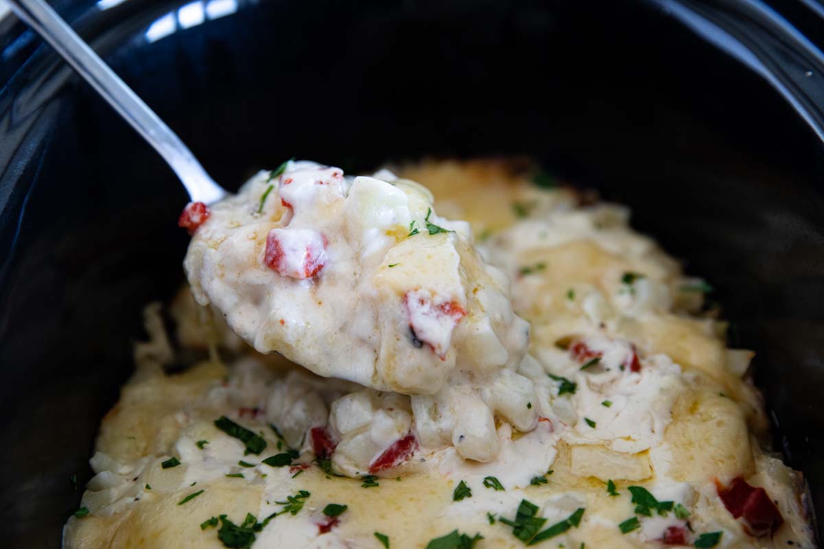 spoonful of cooked potatoes in a slow cooker.