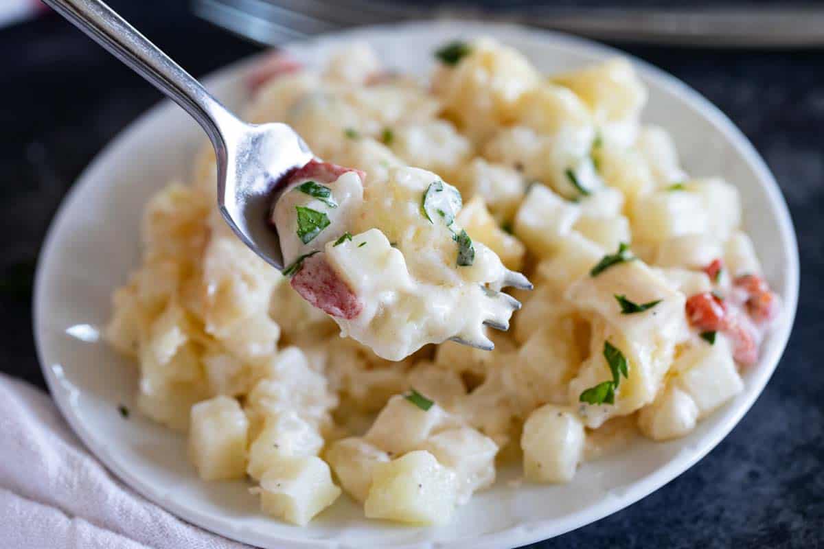 Taking a bite of crockpot cheesy potatoes.