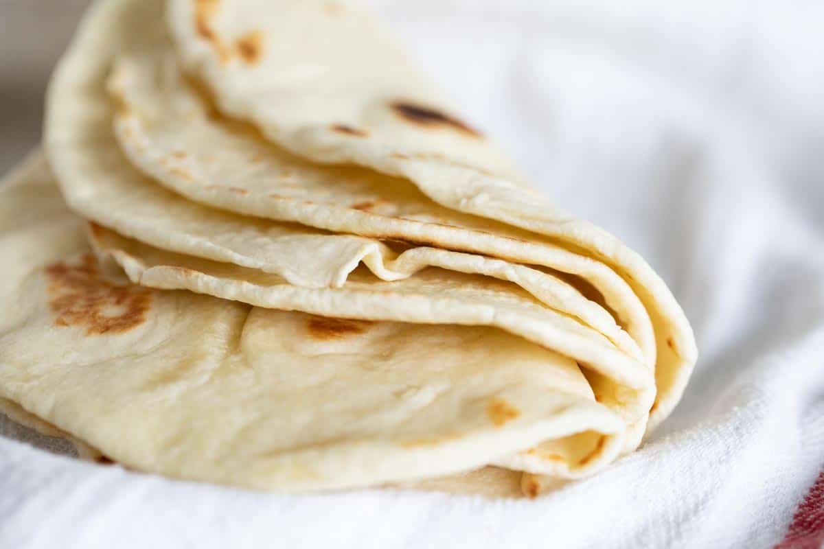 stack of flour tortillas folded in half.