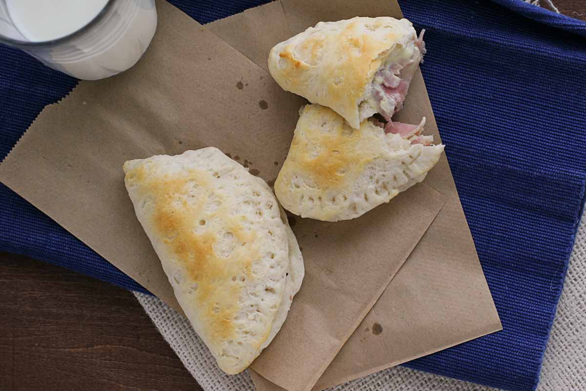 Ham and Cheese Pockets with one broken open to show filling.