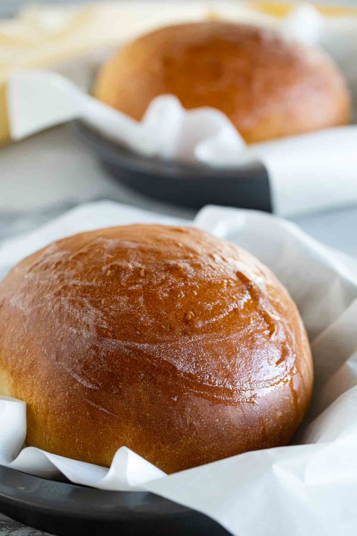 boules of hawaiian bread in parchment paper