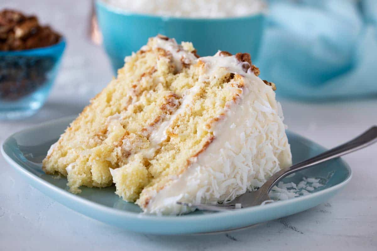 slice of photo collage of steps to make an Italian Cream Cake on a plate with a fork