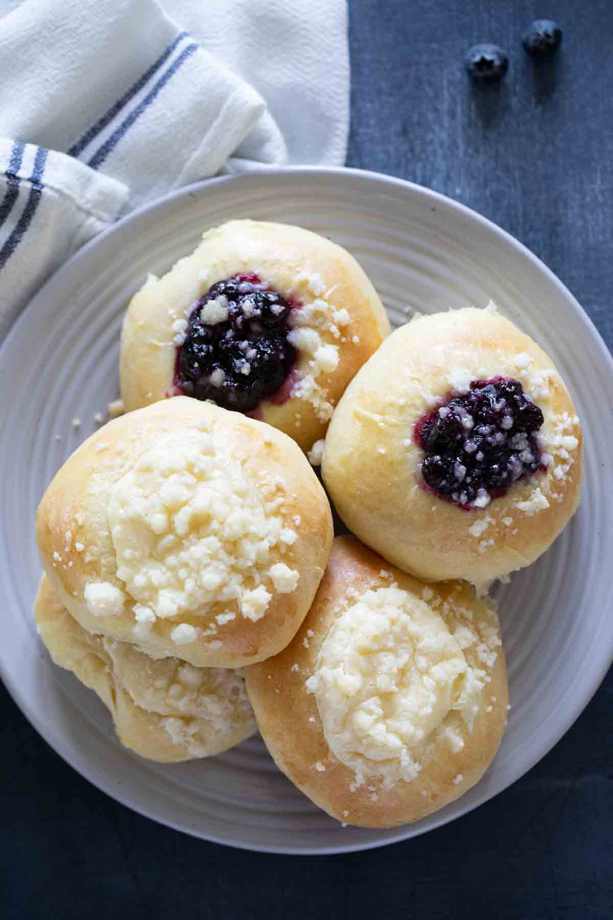 cream cheese and blueberry filled kolaches on a plate