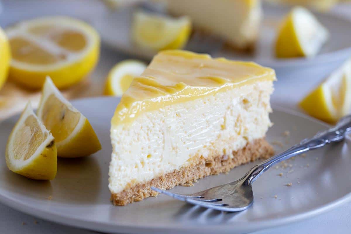 slice of lemon cheesecake topped with lemon curd.