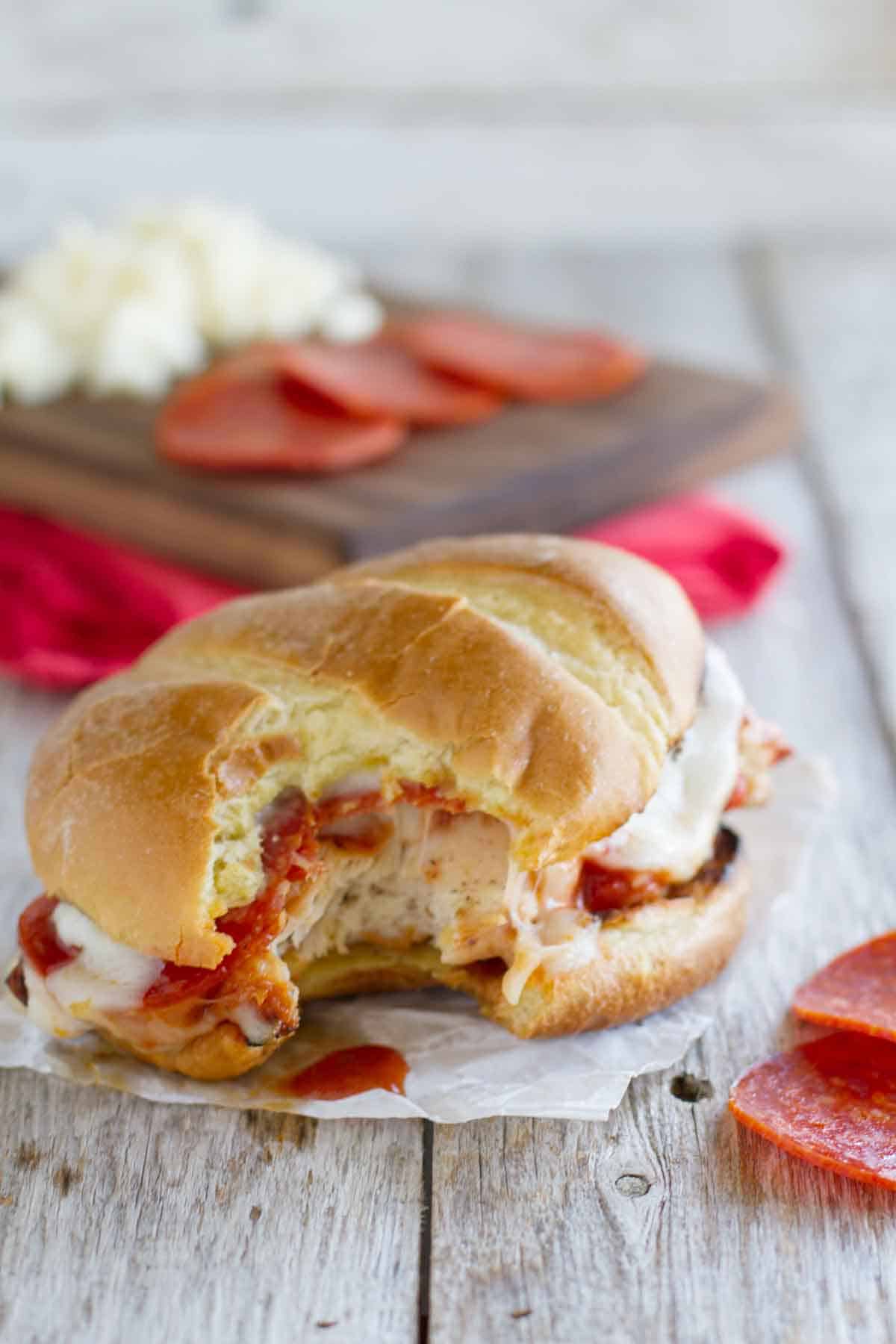 Pizza Topped Grilled Chicken Sandwich with a bite taken from it