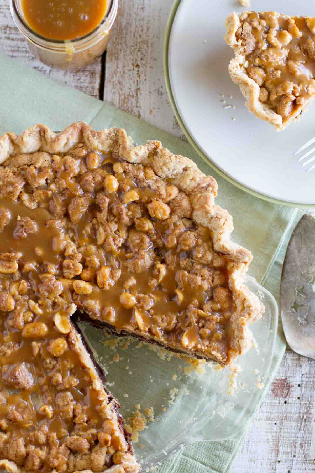 Full Peanut Butter Fudge Pie with a slice taken out.