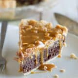 slice of peanut butter fudge pie topped with salted peanut butter caramel.